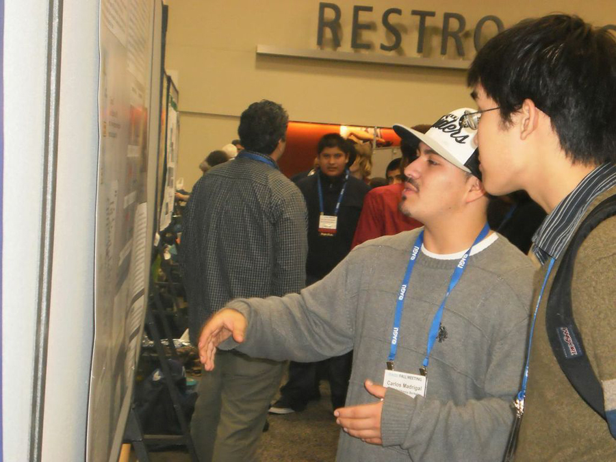 Two students discussing a science poster