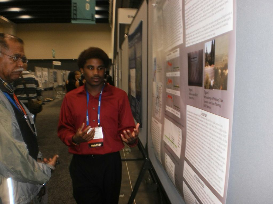 A student presenting information at an event