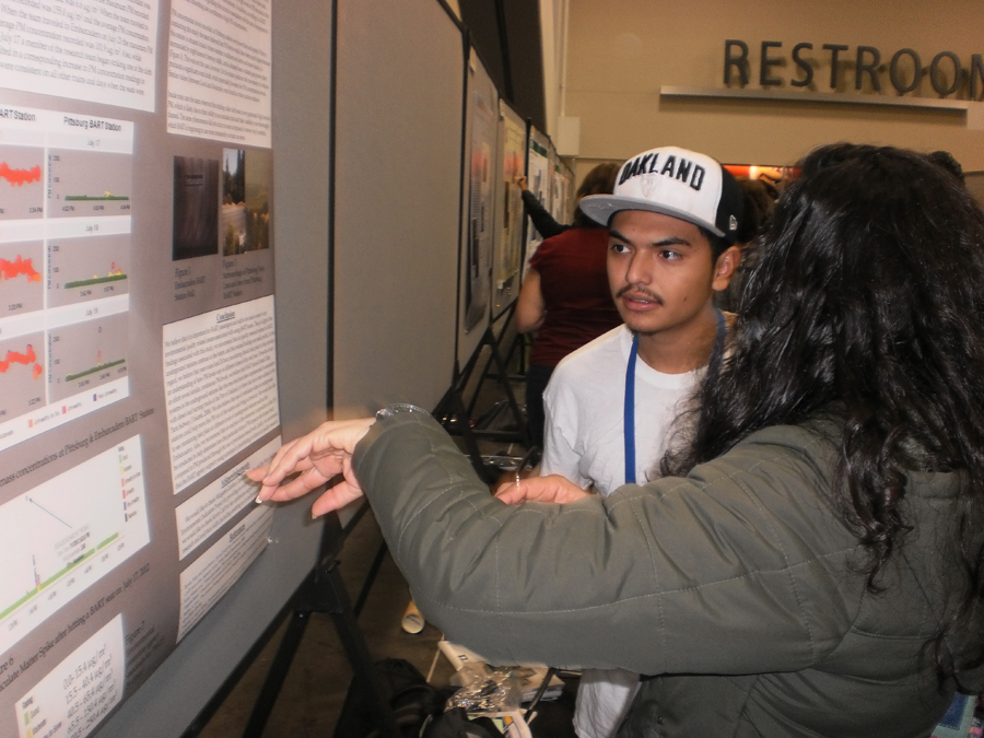 Two students looking at a science poster