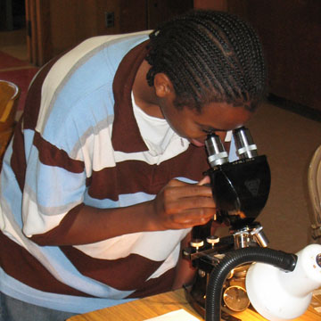 EBAYS student observes a slide under a microscope, 2007