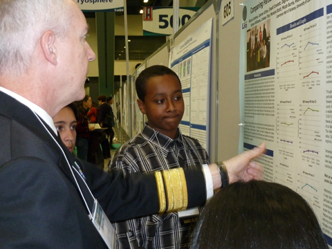 EBAYS students explain charted findings as shown on their poster at the American Geophysical Union (AGU) conference, December 2010
