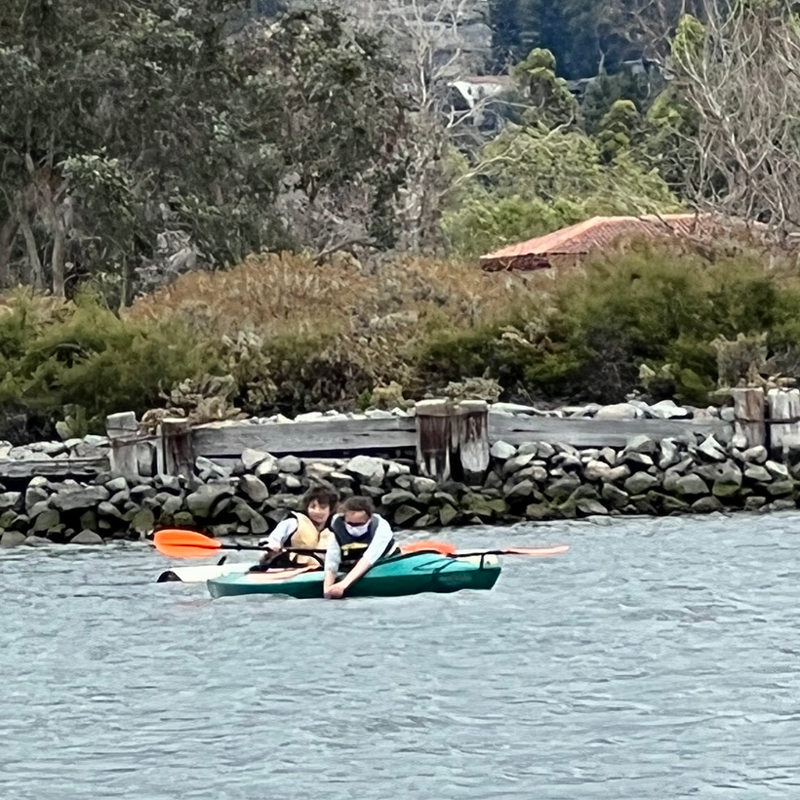 Two people are kayaking in a lake.